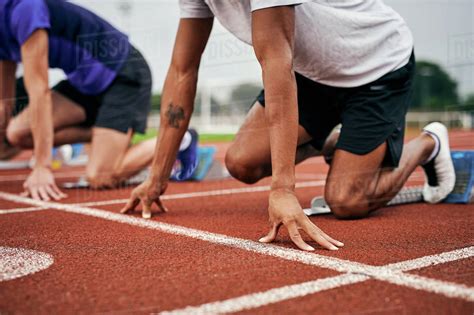 Runners At Starting Line On Running Track Stock Photo Dissolve