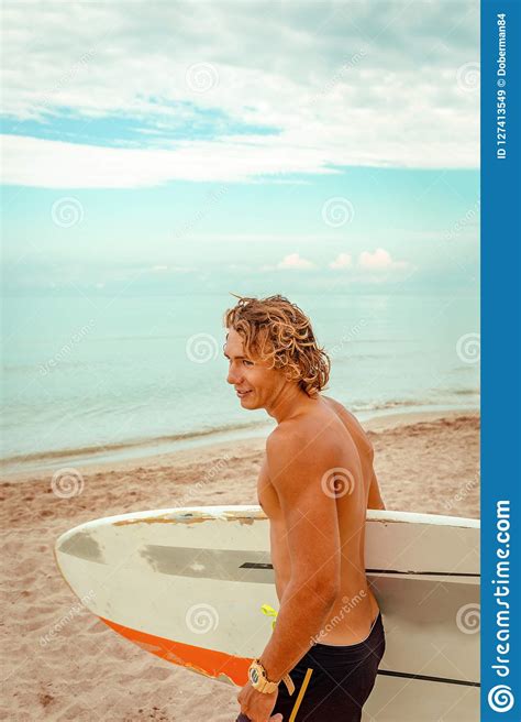 Handsome Man Walk With White Blank Surfing Board Wait For Wave To Surf