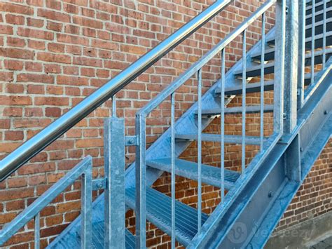 Close Up View On Metallic Stairs In Front Of A Brick Wall 10777015