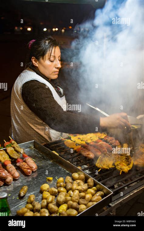 Cuenca, Ecuador - Street food vendor prepares shish kabob of sausage ...