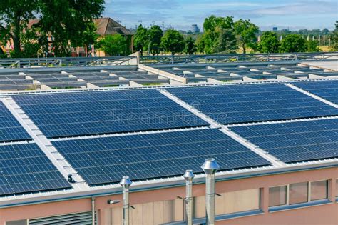 Solar Panels Installed On A Roof Of A Large Industrial Building Or A