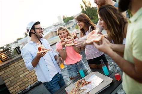 Friends And Pizza Young Cheerful People Eating Pizza And Having Fun