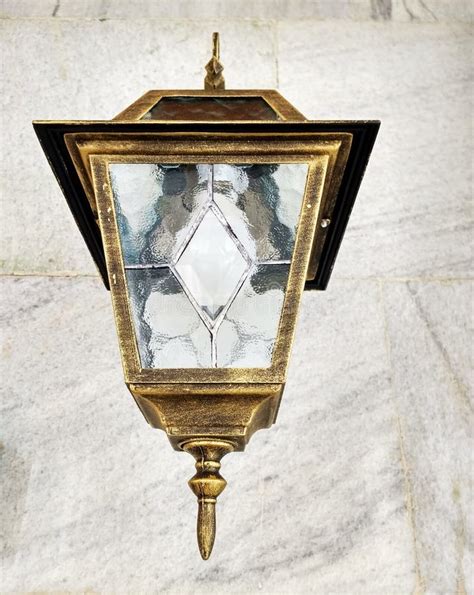 Vintage Bronze Lamp With Frosted Glass Hanging In Front Of The Marble Wall Mobile Photography