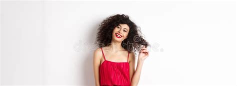 Beautiful Woman With Curly Hair Wearing Red Dress And Lipstick