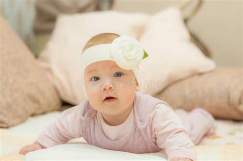 Newborn Child Wearing A Diaper In White Sunny Bedroom Newborn Child