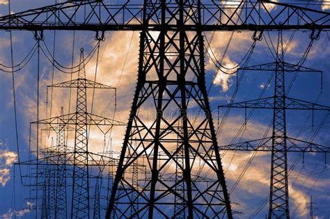 High Voltage Pylons For Electricity And Power Against Sky With Dramatic