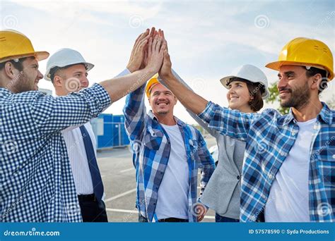 Close Up Of Builders In Hardhats Making High Five Stock Photo Image