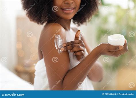 Cropped View Of Young Black Woman Applying Cream On Her Body Pampering