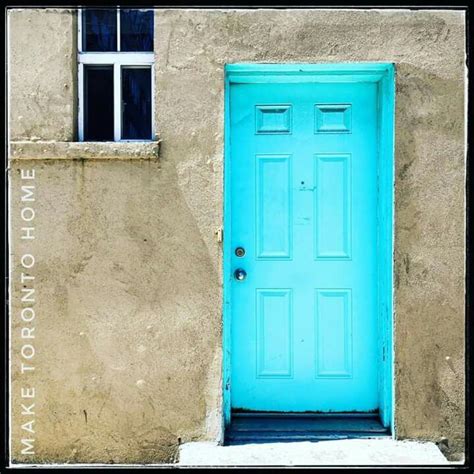 A Blue Door Is In Front Of A Tan Building