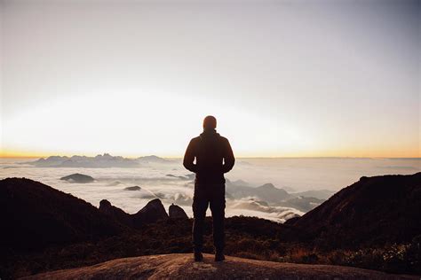 Rear View Of Man Standing On Mountain During Sunset Photograph By Cavan