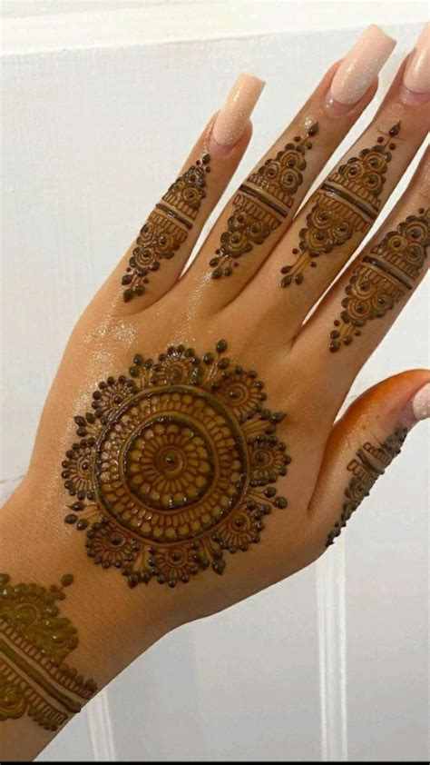 A Womans Hand With Henna Tattoos On It