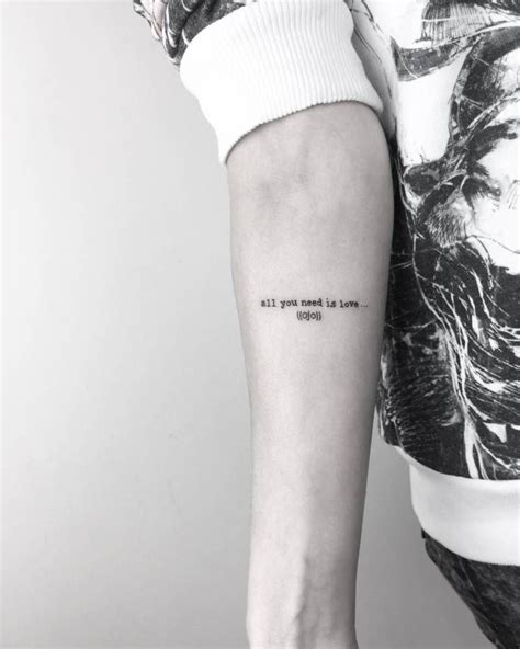 A Woman S Arm With A Tattoo That Reads All You Need Is Love