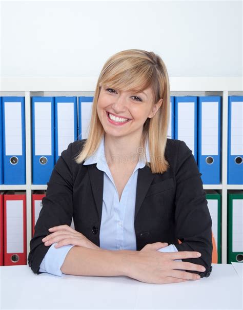 Laughing Businesswoman With Dark Eyes And Blonde Hair At Office Stock