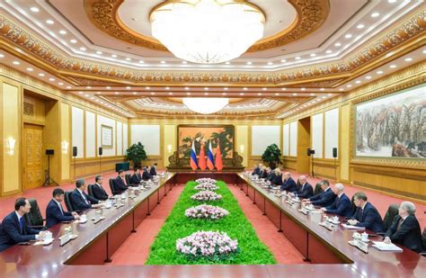 Xi Meets With Russian PM Xinhua