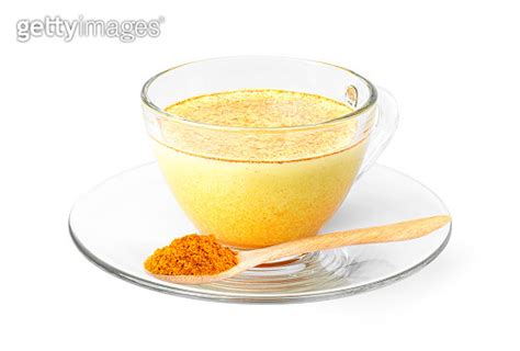 Golden Milk Turmeric Latte In Glass Cup With Tumeric Powder In