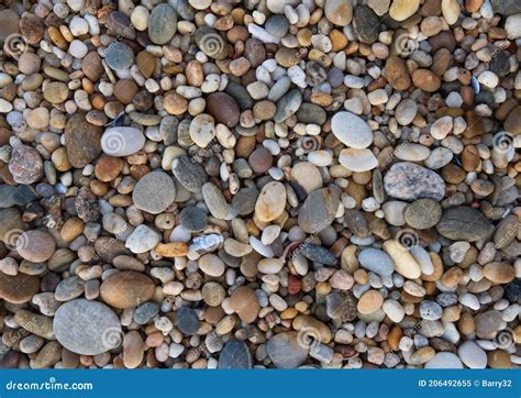 Close Up Of Round Smooth Pebbles On Beach Natural Background Texture