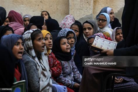 Displaced Palestinian children attend a Quran class at Bear al-Saba