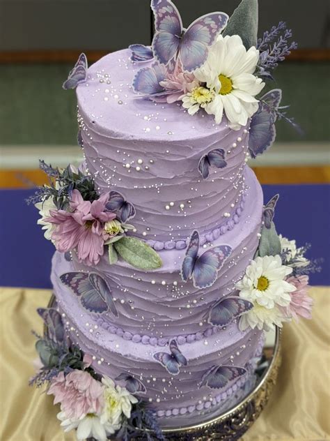 There Is A Purple Cake With Flowers On It