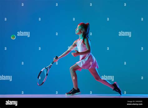 Portrait Of Little Girl Beginner Tennis Player Playing Tennis Isolated