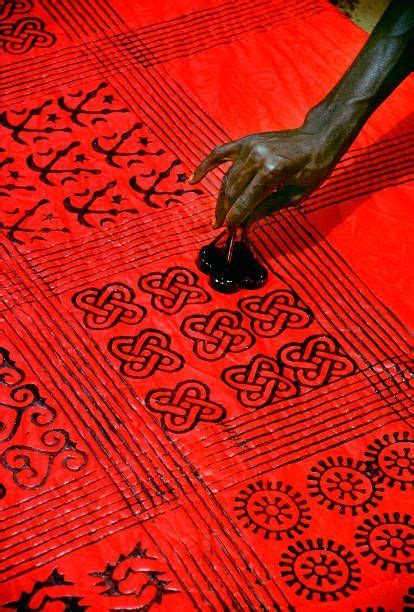 An Artisan Stamps Adinkra Cloth In The Village Of Ntonso Near Kumasi