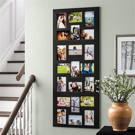 A Wall Hanging On The Side Of A Staircase With Pictures And Flowers In