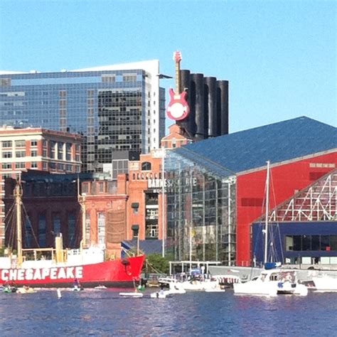 Boats Are Docked In The Water Near Some Buildings And Other Tall