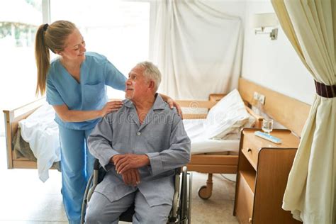 Nurse With Elderly Man Sitting In Wheelchair At Rehab Center Stock Image Image Of Pensioner