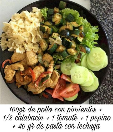 A Black Plate Topped With Pasta And Veggies On Top Of A White Table