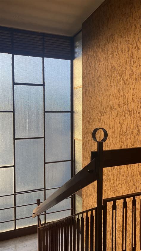 An Iron Railing In Front Of A Window With Frosted Glass On The Outside Wall