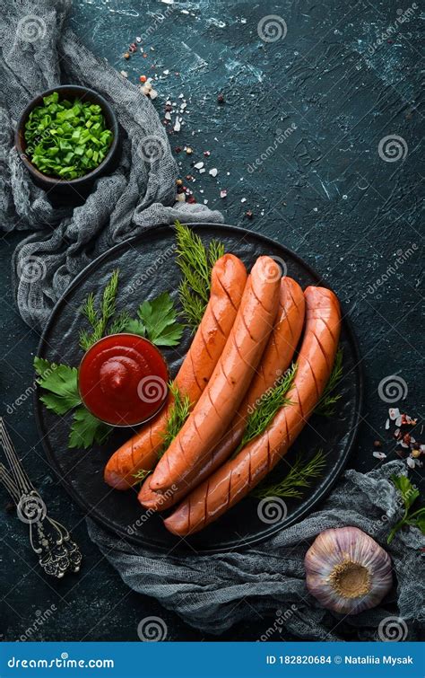 Boiled Sausage With Ketchup On A Black Plate Stock Photo Image Of