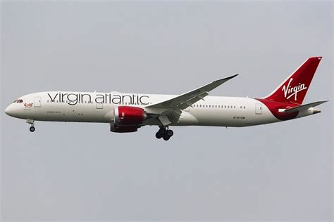 A Virgin Atlantic Plane Flying In The Sky With It S Landing Gear