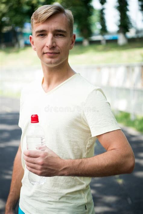 Sportsman With Plastic Bottle On Sunny Outdoor Thirsty Man With Water