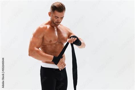 Man Athletic Bodybuilder Poses In Boxing Gloves With Nude Torso Abs In Full Length Background