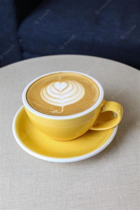 Premium Photo | Coffee art in a hot aesthetic yellow coffee cup