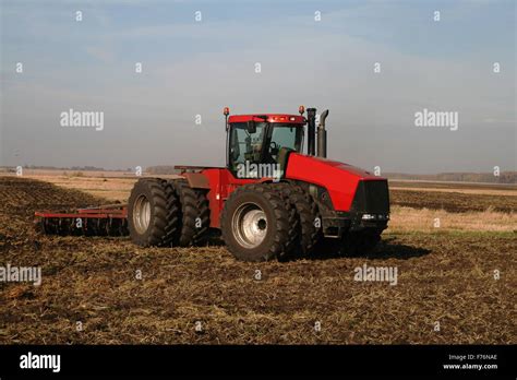 Tractor and harrow Stock Photo - Alamy