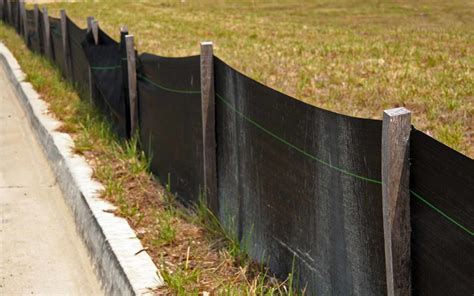 Black erosion barrier with wood stakes - Varsity Inc