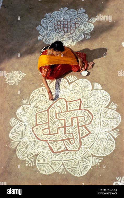 India Woman Painting Rangoli Design For Diwali Festival Stock Photo