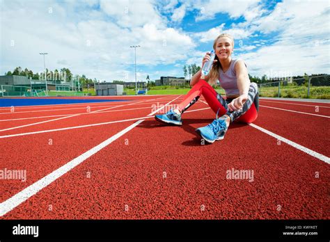 Happy Young Woman Drinking Water On Running Tracks Stock Photo Alamy