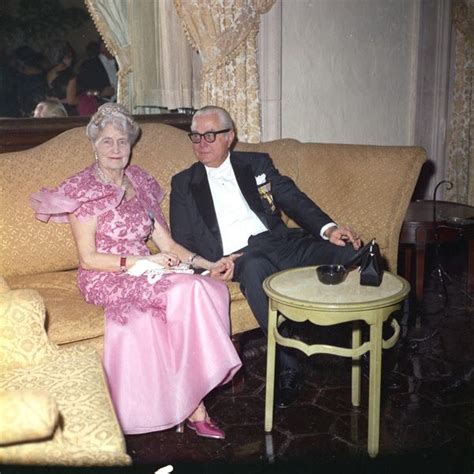 An Older Man And Woman Sitting On A Couch