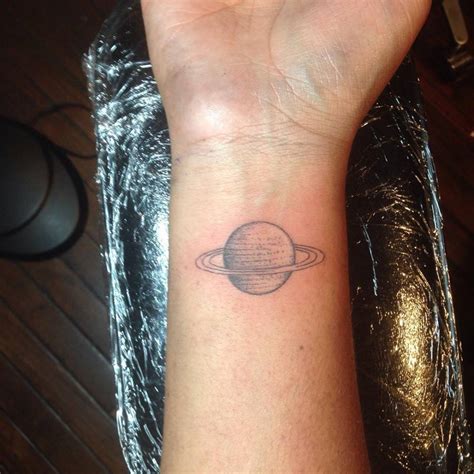 Saturn Tattoo Located On The Wrist Illustrative Style