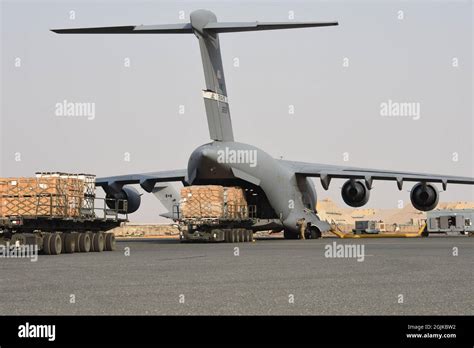 The Th Expeditionary Airlift Squadron Loads Pallets Of Cots On To A