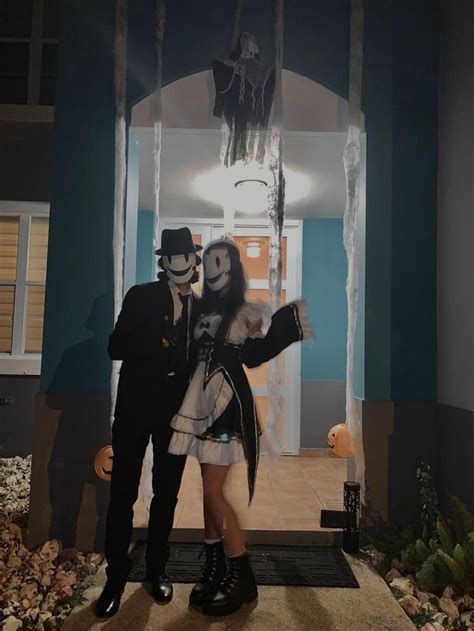 A Man And Woman Dressed Up In Halloween Costumes