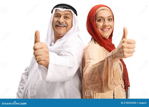 Muslim Man And Woman Smiling At Camera And Showing Thumbs Up Stock