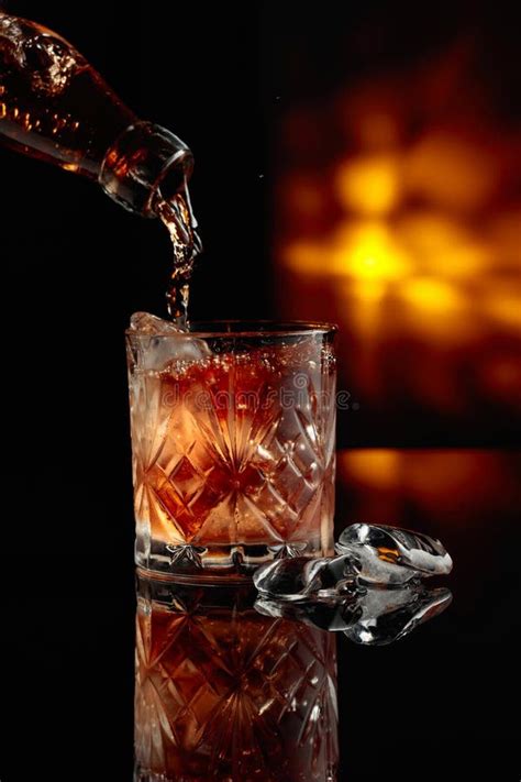 Pouring Whiskey Into A Glass With Ice Stock Photo Image Of Liquid