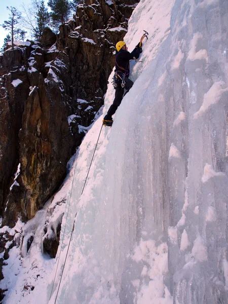 Man Climbing Frozen Waterfall Stock Photo By Vetal