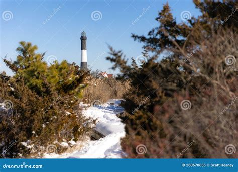 Snowy Path Leading To A Lighthouse In A Wintery Scene Fire Island Long