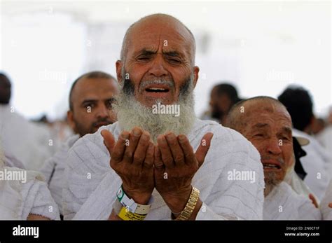 An Afghani Muslim Pilgrim Prays After He Casts Stones At A Pillar