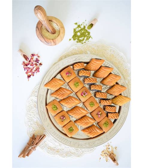 There Is A Platter Full Of Small Pastries On The Table Next To Spices