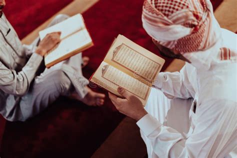 A Group Of Muslims Reading The Holy Book Of The Quran In A Modern