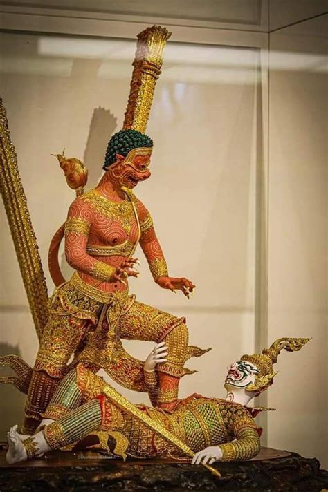 An Elaborately Decorated Statue Is Displayed In A Glass Case With A Man